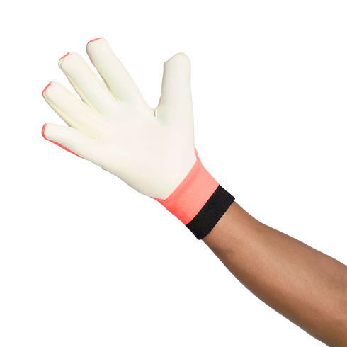 A person's arm and hand wearing a white goalkeeper glove with a coral and black wrist cuff, fingers spread open against a white background.