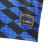 Close-up of a blue and black diamond-patterned fabric with repeated AFA logos and a yellow-bordered Thrasher and Argentine Football Association patch.