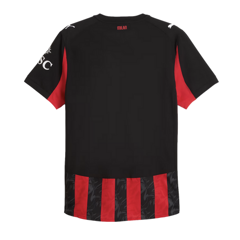 Back of a black AC Milan jersey with red accents, white Puma logos on the shoulders, and red-and-black stripes at the bottom. "MILAN" is printed on the back collar.