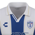 Close-up of a white and blue striped Pachuca soccer jersey with a white polo collar, featuring the Charly logo and club crest.