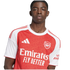 Portrait of a young Black man wearing an Arsenal FC home football shirt against a white background.