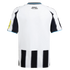 Back of a white Newcastle United football jersey featuring black stripes, light blue trim, and "HOWAY THE LADS" text on the upper back.