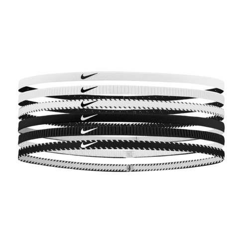 A set of six thin Nike headbands in black and white, featuring solid, ribbed, and zigzag patterns with the iconic swoosh logo on each.