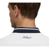 Close-up back view of a man's head and neck. He wears a white shirt with a navy striped collar and the "KidSuper" script logo printed on the upper back.