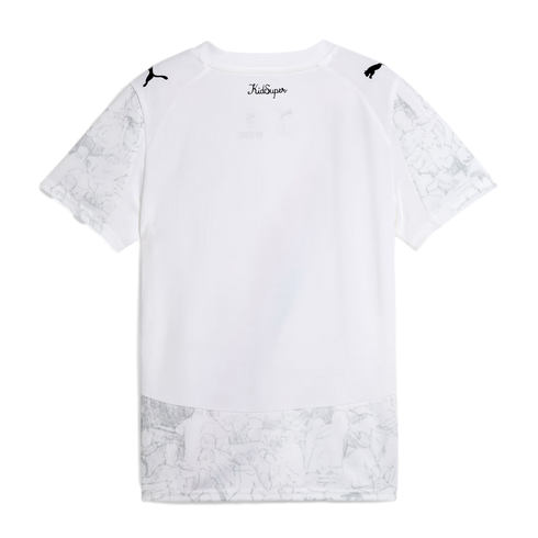 Back view of a white short-sleeved Puma t-shirt. Features black shoulder logos, 'KidSuper' neck branding, and a light gray sketched pattern on the sleeves and bottom panel.