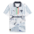White Puma Monterrey soccer jersey featuring grey brushstroke stripes, green and red accents, and a watercolor mountain landscape graphic on the bottom half.
