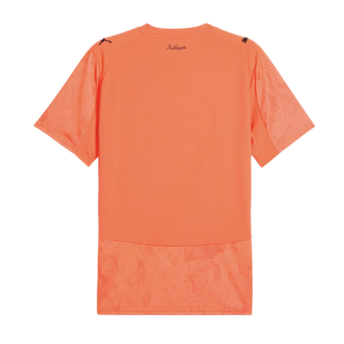 Back view of a short-sleeved orange jersey with "KidSuper" script at the neck, Puma logos on the shoulders, and tonal graphic illustrations on the sleeves and bottom hem.