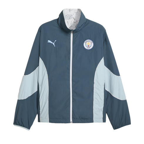 A teal and light blue Puma Manchester City track jacket featuring a white front zipper and the club crest on the chest.