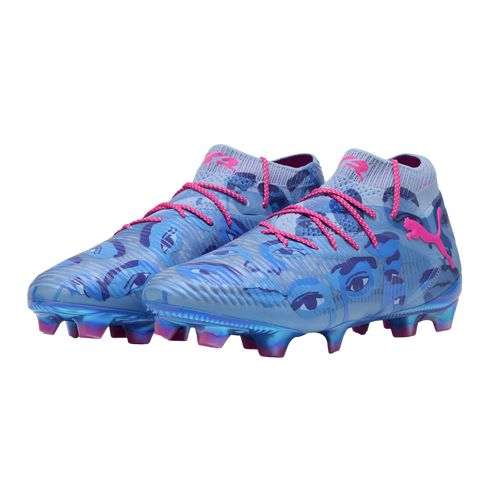A pair of light blue Puma soccer cleats with dark blue eye graphics, pink laces, and pink logos. The soles feature iridescent blue and pink studs.