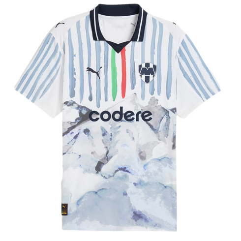White Puma soccer jersey for CF Monterrey featuring blue brushstroke stripes, a watercolor mountain landscape graphic, and the "codere" sponsor logo.