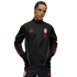 A male model wearing a black AC Milan x Puma 'KING' tracksuit with red accents and white piping, set against a plain white background.