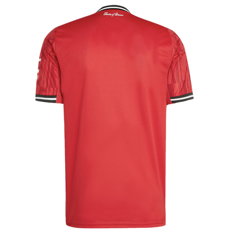 Back of a red football jersey with black and white striped collar and cuffs. "Theatre of Dreams" is printed in white script on the upper back.