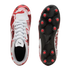 Top and bottom views of white Puma soccer cleats with red and black graphic designs, white laces, and black outsoles with red circular studs.