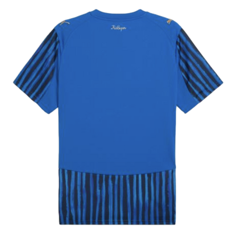 Rear view of a blue Puma soccer jersey with black-striped sleeves and a textured striped hem. Features a small 'KidSuper' logo below the back neckline.