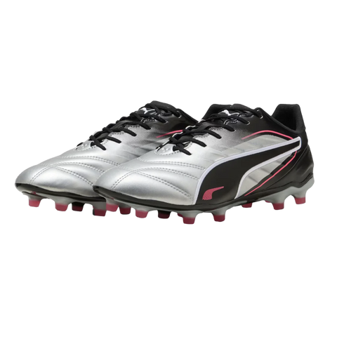 A pair of silver and black Puma soccer cleats with pink accents and studs, displayed against a solid black background.