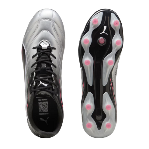 Top and bottom views of a Puma soccer cleat with a silver and black gradient upper and pink studs on its soleplate, set against a black background.