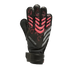 Black Adidas Predator goalkeeper glove featuring pink textured accents, grey side stripes, and an adjustable wrist strap, set against a black background.