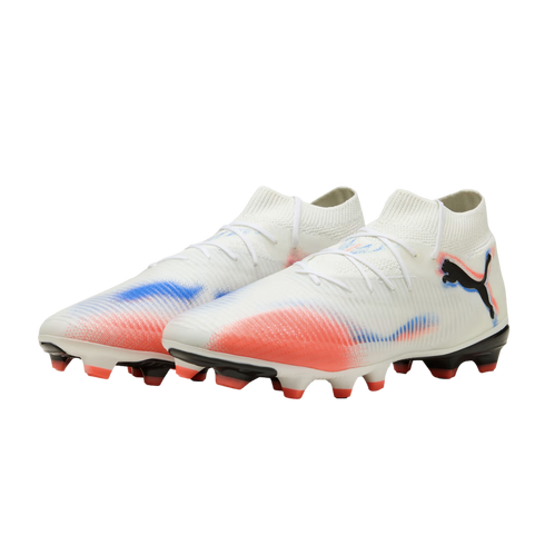 A pair of white Puma soccer cleats with red and blue graphic accents and a black logo, set against a solid black background.