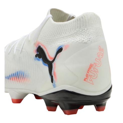 White Puma Future soccer cleat with red and blue accents, black logo, and "PLAY FREE FUTURE" on the heel. Features a knitted collar and black soleplate with red-tipped studs.