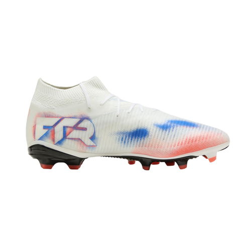White soccer cleat featuring red and blue spray-paint style graphics, "FTR" branding on the heel, and a black sole with red studs, shown against a black background.