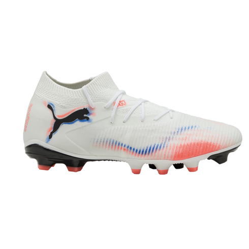 White Puma soccer cleat with red and blue spray-paint accents, featuring a black logo, white laces, and a sock-like collar against a black background.