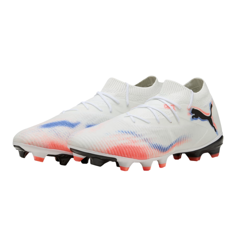 A pair of white Puma soccer cleats with red and blue graphic accents and a black logo, shown against a black background.