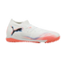 A white Puma turf soccer shoe featuring a black logo, vibrant orange and blue graphics, and an orange textured sole, set against a black background.