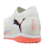 White Puma Future soccer turf shoe with black logo, coral and blue accents, and a bright coral studded rubber outsole.