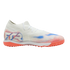 White turf soccer shoe with red and blue graphics, "FTR" branding on the heel, and a red-orange studded outsole. Shown from a side profile against a black background.