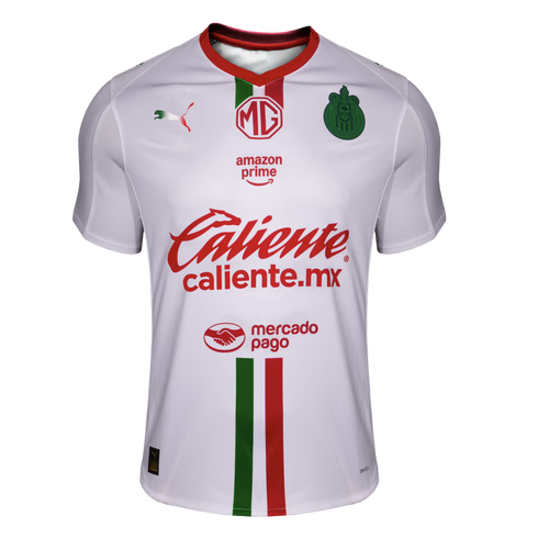 A white Puma soccer jersey for Chivas (C.D. Guadalajara) featuring a red collar, vertical green and red stripes, and sponsors MG, Amazon Prime, Caliente, and Mercado Pago.