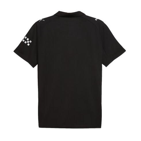 Back view of a black short-sleeved polo shirt featuring silver Puma logos on the shoulders and a checkered flag graphic on the left sleeve.