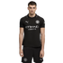 A man wearing a black Manchester City soccer kit with silver logos and sponsors, set against a solid black background.