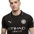 A young man wearing a black Manchester City soccer jersey with silver club crest, Puma, and Etihad Airways logos.