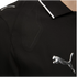 Close-up of black athletic wear with a metallic silver Puma logo. The garment features a textured mesh panel and a black collar with thin white trim.