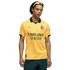 A man wearing a yellow AC Milan soccer jersey, dark green shorts, and yellow sunglasses on his head, posed against a black background.