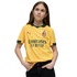 A young girl with long brown hair poses in a yellow AC Milan football jersey and black pants against a black background.