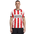 A man models a red and white striped PSV Eindhoven Puma soccer jersey featuring the "Brainport Eindhoven" sponsor logo on a solid black background.