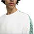 Person wearing a white AC Milan sweatshirt with green patterned sleeve trim and a faint chest crest.