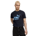 A person with short blonde hair wears a dark blue Manchester City T-shirt and black jeans against a black background.