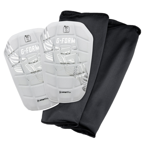 A pair of white G-Form soccer shin guards with silver graphics and two black mesh sleeves on a black background.