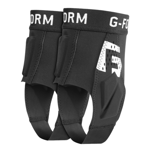 Pair of black G-Form ankle guards with impact-absorbing padding, white branding, and under-foot stirrup straps.