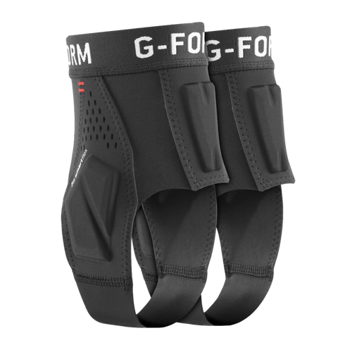 A pair of black G-Form ankle protectors featuring impact-absorbing padding and a stirrup-style strap, shown against a black background.