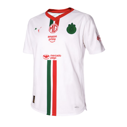 White Chivas soccer jersey featuring green and red vertical stripes and logos for MG, Amazon Prime, Mercado Pago, and Puma. Red V-neck collar.