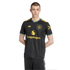 A man wearing a black Manchester United soccer jersey with yellow and blue accents and the Snapdragon logo, against a black background.