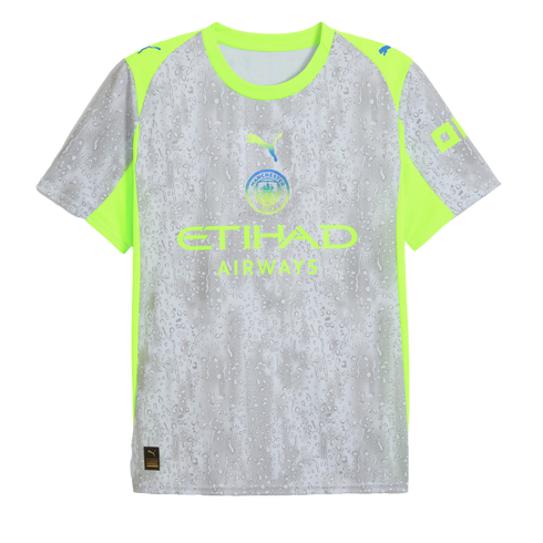 A silver Manchester City soccer jersey featuring a water droplet pattern, neon yellow accents on the shoulders and sides, and the Puma and Etihad Airways logos.
