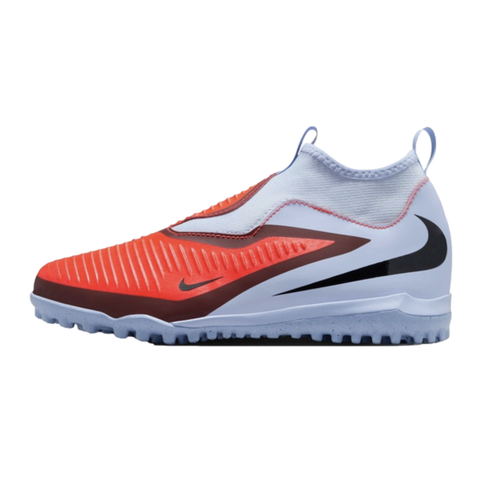 A laceless Nike soccer shoe with a textured orange forefoot, light blue upper, and black Swoosh, featuring a studded outsole for turf surfaces.