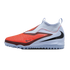 A laceless Nike soccer shoe with a textured orange forefoot, light blue upper, and black Swoosh, featuring a studded outsole for turf surfaces.
