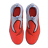Top-down view of a pair of Nike slip-on athletic shoes featuring a bright orange ribbed forefoot and light blue knit collar.