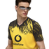 A man wears a yellow and black Puma BVB jersey and futuristic sunglasses against a black background.