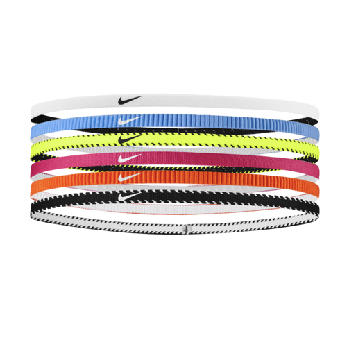 Six thin Nike headbands stacked vertically in white, light blue, neon yellow, magenta, orange, and black-and-white patterned colors.